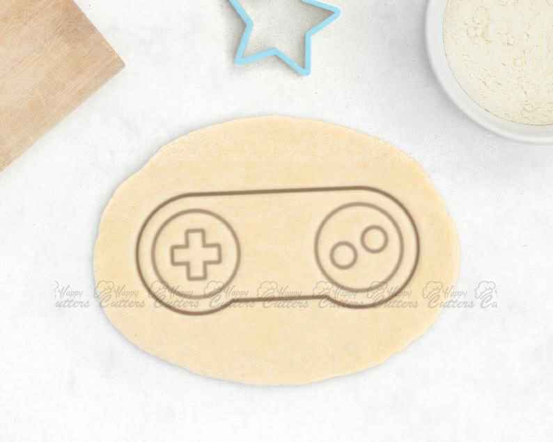 Retro Video Game Cookie Cutter – Video Game Controller Cookie Cutter Retro Gaming Gift,
                      xbox controller cookie cutter, xbox cookie cutter, ps4 controller cookie cutter, ps4 cookie cutter, nintendo cookie cutters, minecraft fondant cutter, bow tie cookie cutter, sea life cookie cutters, snoopy cookie cutter, bear head cookie cutter, boat cookie cutter, feminist cookie cutters, cookie shapes, castle cookie cutter,
                      